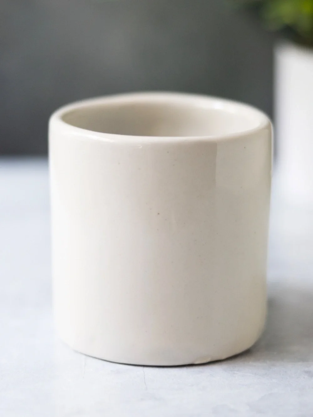 West Elm white ceramic bird planter with beak and gray black eyes 3.75
